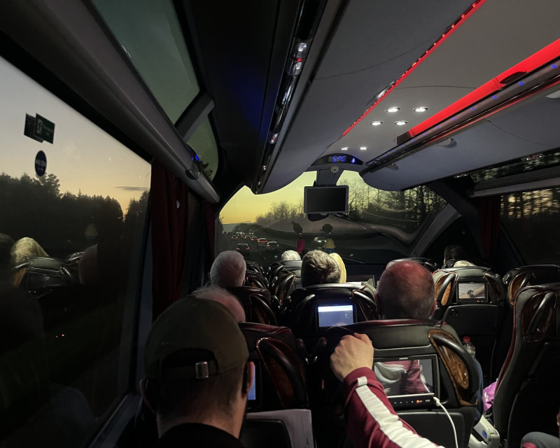 View south along the A38 at sunset, from inside a coach with panoramic window arrangement