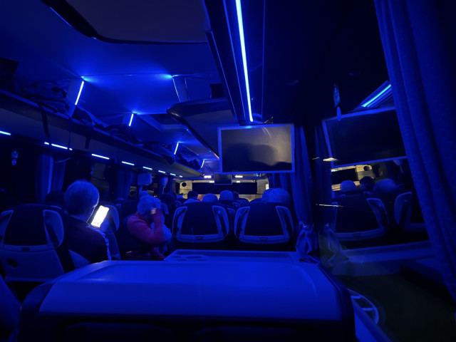 Internal view of a coach, travelling on the motorway, at night