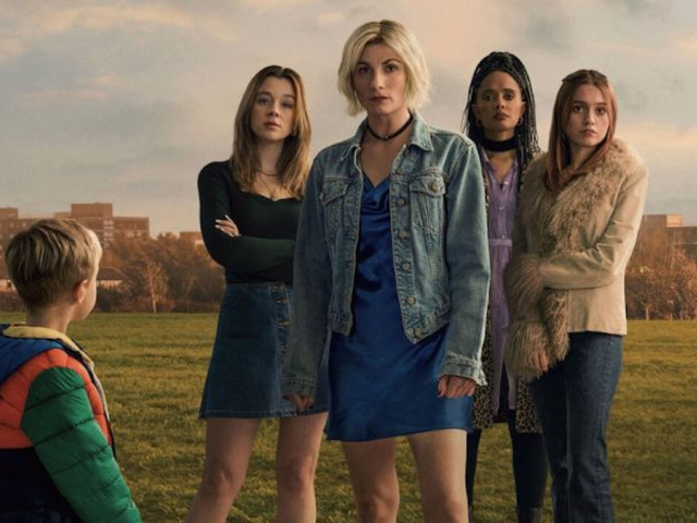 Cover image from Toxic Town, with four women in a field in the centre of the picture, looking towards the camera as a young boy in a green coat looks back towards them.
