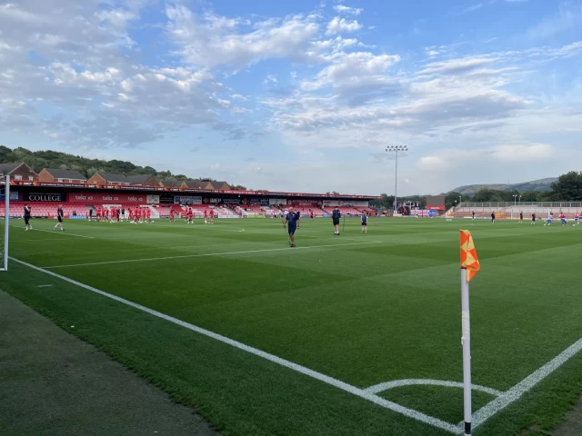 Picture looking across the pitch before kickoff at the Wham Stadium, with blue skies and white clouds above