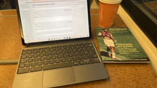 Lenove Duet 11 on train table alongside a copy of the London Clarets' journal 'Something to Write Home About"